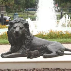 bronze sculpture of a lion and lamb