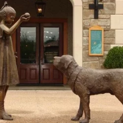bronze state of girl playing with dog life size statue