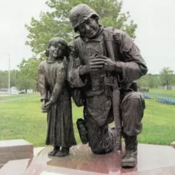 life size bronze memorial of a soldier and little girl