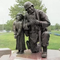 bronze statue of a soldier and little girl