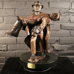 small sculpture of a man carrying a soldier