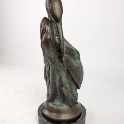 bronze statue of a heron with an antiqued patina