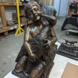 bronze sculpture of a little girl with a goose