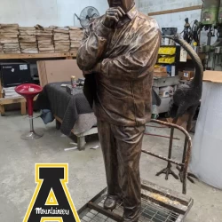 life size bronze statue of the app-state-coach-with-logo